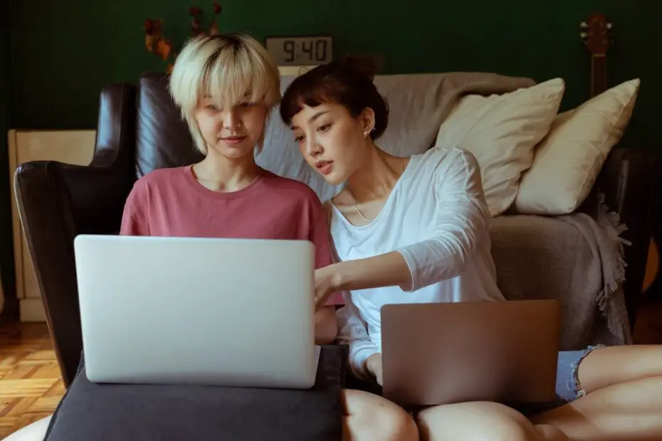 Two women looking at a laptop screen